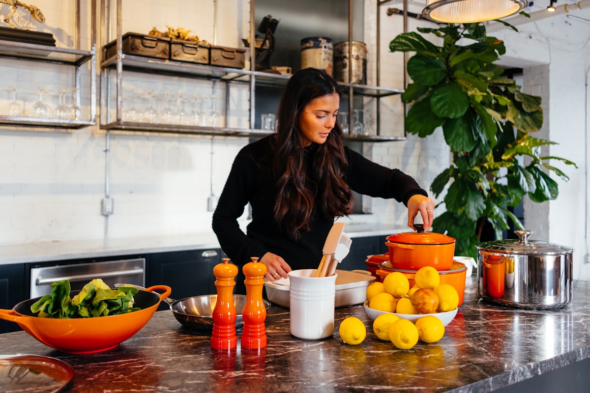 Whole foods cooking preparation with fresh vegetables and grains